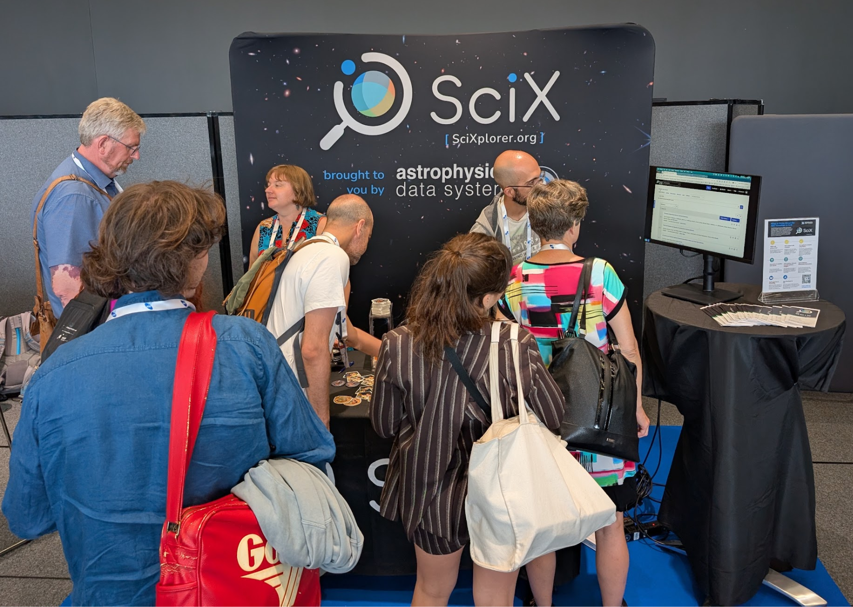 Conference attendees visiting the SciX booth at the EAS 2026 exhibit hall.
