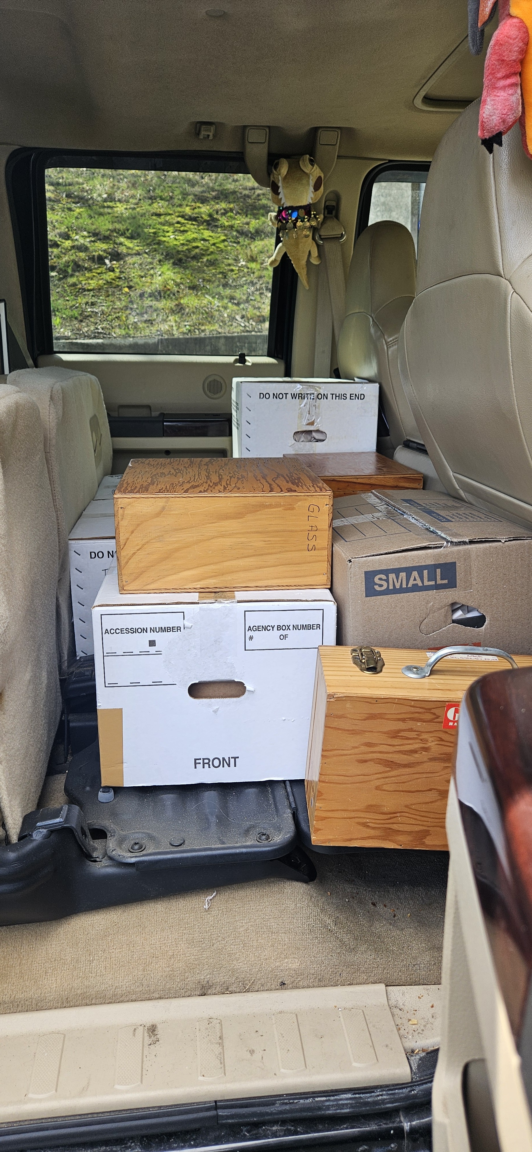 Boxes of material stacked in the back of a vehicle